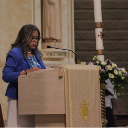 A lector reading from the ambo