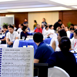 sheet music with conference meeting in the background