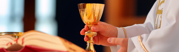close of a priest consecrating hosts during Catholic Mass