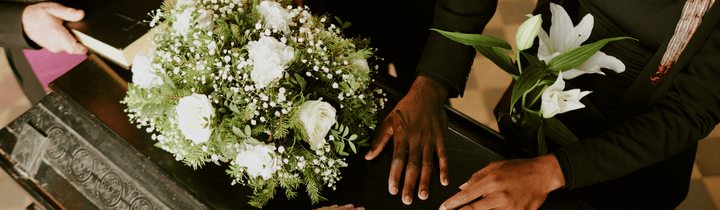 Close up of casket with flowers on top